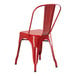 A Lancaster Table & Seating ruby red metal outdoor table with 2 red metal chairs.