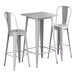 A Lancaster Table & Seating nickel gray bar height outdoor table with 2 chairs.