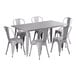 A Lancaster Table & Seating nickel gray outdoor table with 6 chairs.