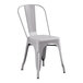 A Lancaster Table & Seating nickel gray metal chair with a back.