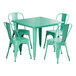 A Lancaster Table & Seating outdoor table with an aquamarine top and white legs with four green chairs around it.