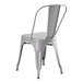 A Lancaster Table & Seating nickel gray metal outdoor chair with a backrest.