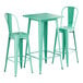 A Lancaster Table & Seating aquamarine table with two barstools.