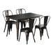 A Lancaster Table & Seating distressed copper outdoor table with black metal chairs.