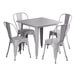 A white Lancaster Table & Seating outdoor table with a nickel gray metal frame and four white chairs.