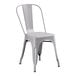 A grey metal chair with a back.