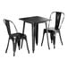 A Lancaster Table & Seating black metal table with two chairs.