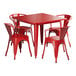 A red square Lancaster Table & Seating outdoor table with red metal legs and four red chairs.