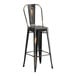 A Lancaster Table & Seating bar height table with black metal chairs with wooden seats.