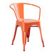 An orange metal arm chair.