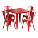 A Lancaster Table & Seating red metal table and four chairs.