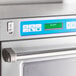 A close up of a Solwave commercial steamer microwave oven with a blue screen.