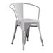 A gray metal Lancaster Table & Seating outdoor chair with arms and a back.