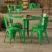 A jade green table with chairs outside on a patio.