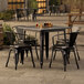 A Lancaster Table & Seating outdoor table and chairs on a patio.