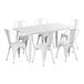 A white Lancaster Table & Seating outdoor table with six white chairs.