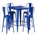 A blue square table with blue metal chairs.