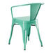 A green metal chair with arms and a backrest.