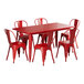 A Lancaster Table & Seating ruby red table with six chairs on a patio.