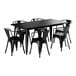 A Lancaster Table & Seating onyx black rectangular table with six black chairs.