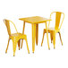 A Lancaster Table & Seating citrine yellow metal table with two chairs.