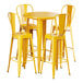 A Lancaster Table & Seating citrine yellow table with 4 yellow barstools.