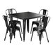 A Lancaster Table & Seating black metal table with four black chairs.