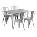 A Lancaster Table & Seating outdoor table with a white surface and 4 white chairs.