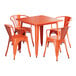 An orange metal Lancaster Table & Seating outdoor table and chairs set.