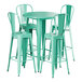 A Lancaster Table & Seating aquamarine table with four green metal chairs.