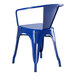 A blue metal Lancaster Table & Seating chair with arms on a blue outdoor table.