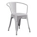 A gray metal Lancaster Table & Seating outdoor table with 4 gray metal arm chairs.