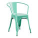 A mint green metal Lancaster Table & Seating arm chair.