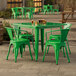 A Lancaster Table & Seating jade green table with four chairs on a stone patio.