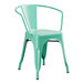 A Lancaster Table & Seating aquamarine metal chair with arms.
