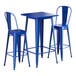 A blue square Lancaster Table & Seating bar table with two chairs.