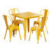 A Lancaster Table & Seating citrine yellow metal table with four chairs.