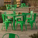 A Lancaster Table & Seating jade green table with chairs on an outdoor patio.