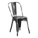 A black metal chair with a white back.