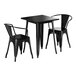 A Lancaster Table & Seating onyx black square table with black metal legs and two black chairs with arms.