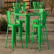 A Lancaster Table & Seating jade green bar height table with four green stools.
