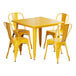 A Lancaster Table & Seating citrine yellow metal table and chairs set with a yellow table and four chairs.