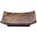 A wooden plate with a brown wood grain design on a table.