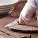 A person using a Choice smooth edge paring knife to cut meat.