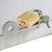 A Regency padlocked sliding lid with 2 keys on a metal surface.