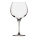 A close-up of a Nude Primeur wine glass with a stem.