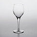 A Nude Primeur wine glass on a white surface.