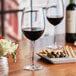 A table with a glass of red wine on it.