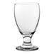 A clear glass goblet with a short stem and wide bowl.