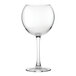 A close-up of a Nude Reserva wine glass with a stem and clear bowl.